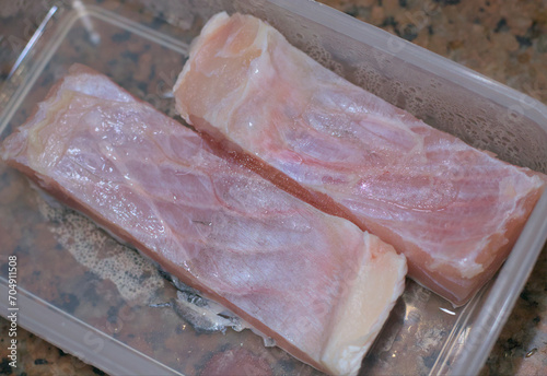 Raw fish cuts out of refrigerator, ready to cook. photo