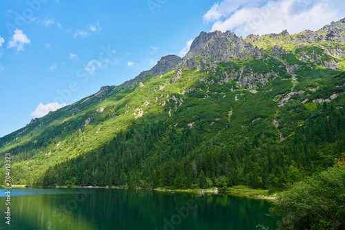 Amazing view on mountains range near beautiful lake at summer day. Tatra National Park in Poland. Panoramic view on Morskie Oko or Sea Eye lake in Five lakes valley