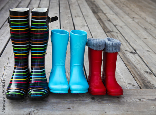 Three pairs of a colorful rain boots © Dasha Petrenko