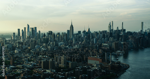 New York City Skyline at Sunset. Aerial Shot of Manhattan from a Helicopter. Panoramic View from the Side of East Village and Generating Station Power Plant on East River