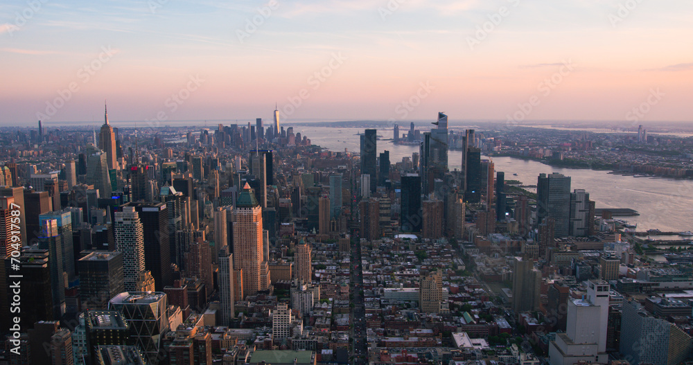 New York City Aerial Evening Cityscape with Stunning Manhattan Landmarks, Skyscrapers and Residential Buildings. Long Wide Angle Panoramic Helicopter View of a Popular Travel Destination