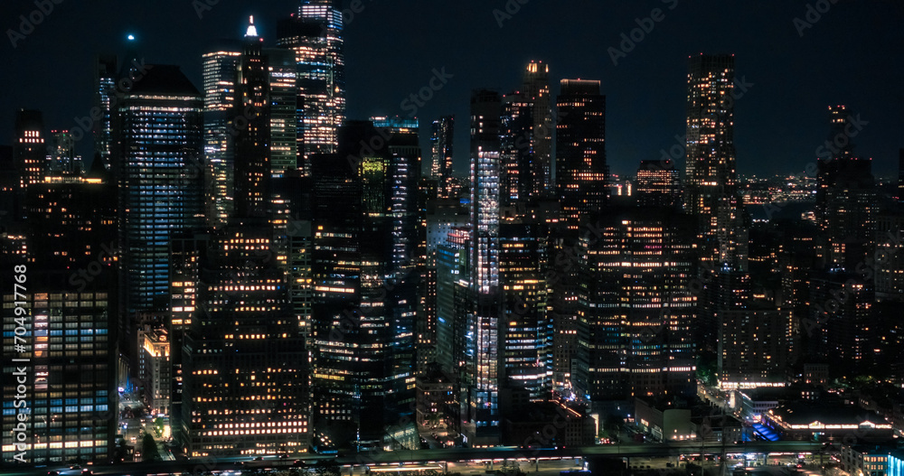 Wall Street Office Buildings Lit Up at Night: Scenic Aerial New York City View of Lower Manhattan Architecture. Panoramic Financial District Shot from a Helicopter. Evening Cityscape of NYC Wall Street Office Buildings Lit Up at Night: Scenic Aerial New York City View of Lower Manhattan Architecture. Panoramic Financial District Shot from a Helicopter. Evening Cityscape of NYC