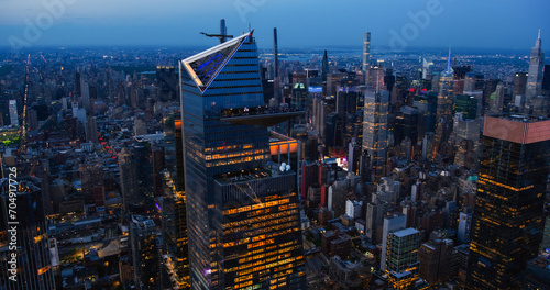 Evening Panorama Around 30 Hudson Yards Skyscraper in New York City, USA. Night Aerial Photo with a Modern Skyscraper with Crowded Observation Balcony. Travelers Looking on the Panorama