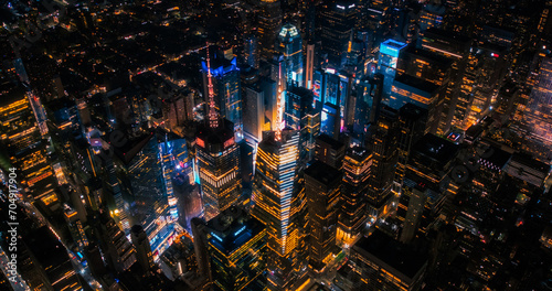 New York Concrete Jungle at Night. Aerial Photo from a Helicopter Tour Around the Center of the Big Apple. Scenes with Times Square District with Crowds of Tourists Enjoying Manhattan Nightlife