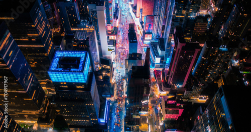 New York Concrete Jungle at Night. Aerial Photo from a Helicopter Tour Around Manhattan. Scenes with Modern Skyscraper Blocking the View on Crowded Times Square Area with Tourists © Gorodenkoff