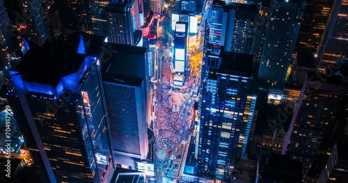 New York Concrete Jungle at Night. Aerial Shot from a Helicopter Tour Around Manhattan. Scenes with Modern Skyscraper Blocking the View on Crowded Times Square Area with Tourists photo