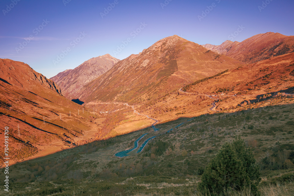 Mountain landscape with blue clear sky during sunset in autumn. Hiking The Pyrenees Mountains In Andorra