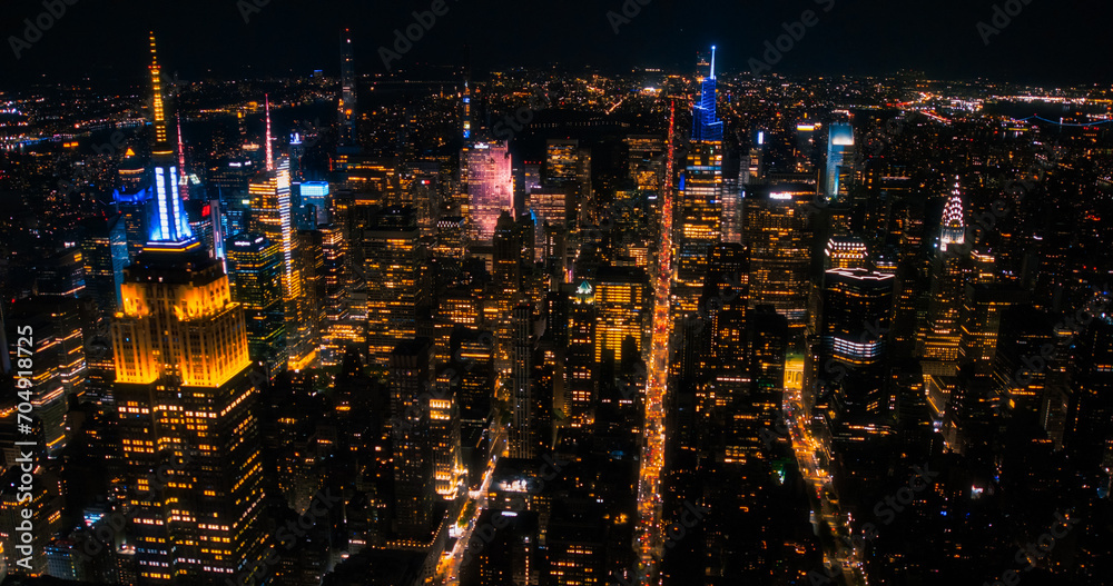 New York City Aerial Night Cityscape with Stunning Manhattan Landmarks, Skyscrapers and Residential Buildings. Wide Angle Panoramic Helicopter View of a Popular Travel Destination