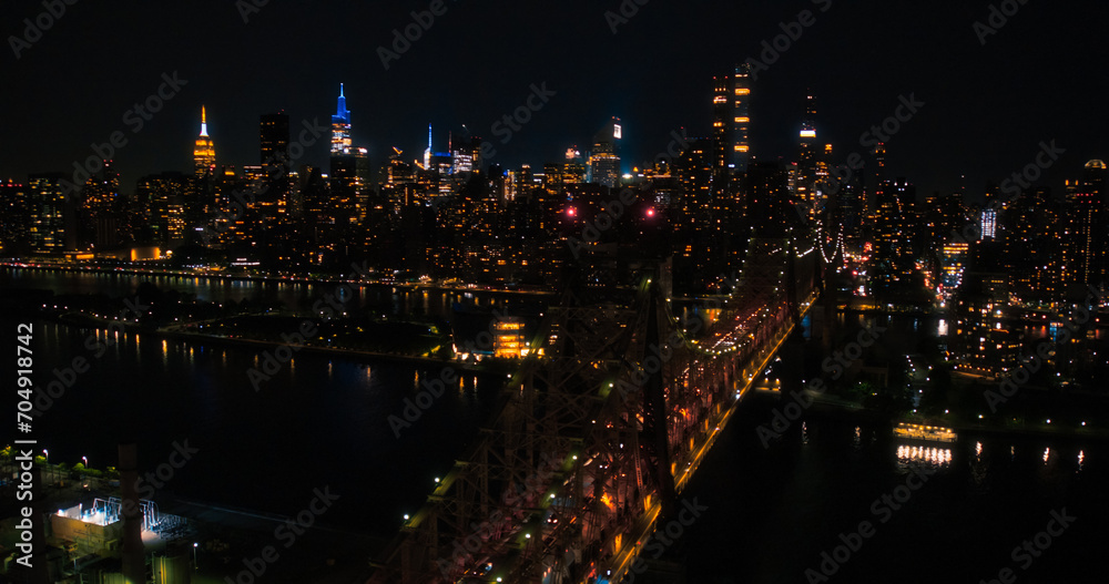 Aerial Helicopter Photo Over Ed Koch Queensboro Bridge with Manhattan Skyscrapers Cityscape. Beautiful Late Evening Shot Focusing on Upper East Side Office Buildings at Night