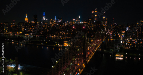 Aerial Helicopter Photo Over Ed Koch Queensboro Bridge with Manhattan Skyscrapers Cityscape. Beautiful Late Evening Shot Focusing on Upper East Side Office Buildings at Night © Gorodenkoff