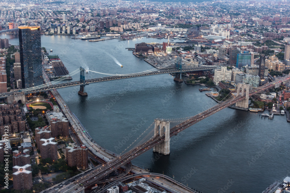 New York City Aerial Shot from a Helicopter at Daytime. Famous Buildings with Manhattan and Brooklyn Bridges. Busy Diverse Megapolis with Cars, Boats and Service Transport Moving Around