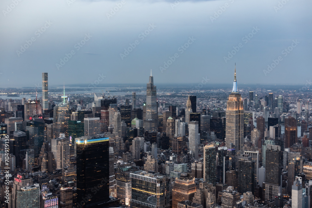 New York City Aerial Evening Cityscape with Stunning Manhattan Landmarks, Skyscrapers and Residential Buildings. Panoramic Helicopter View of a Popular Travel Destination
