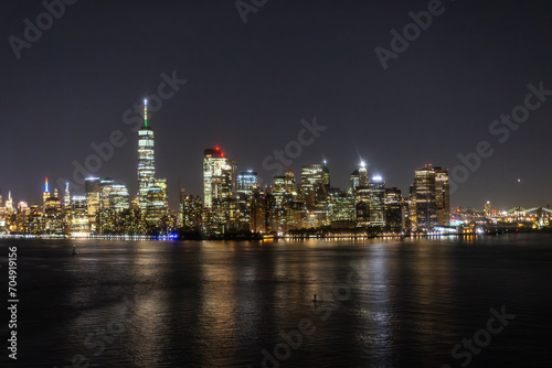 Helicopter Tour of New York City Architecture at Night. Midtown Manhattan Office Buildings and Skyscrapers. Aerial Urban Landscape with Lights at Night © Gorodenkoff