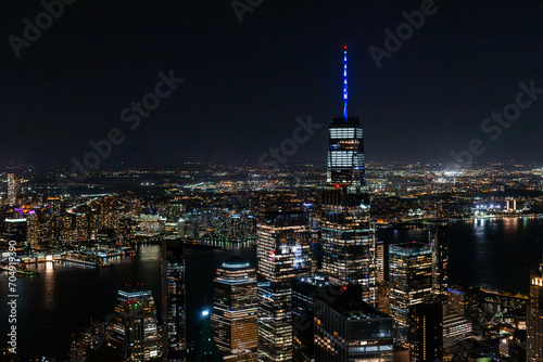 Night Aerial Shot of the One World Trade Center Skyscraper with Antenna. Helicopter Photo of a Group of Glass Buildings in Manhattan © Gorodenkoff