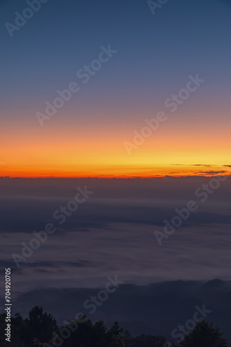 Beautiful autumn dramatic colors sky with mist in the mountains.Morning Amazing nature