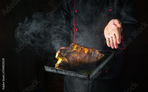Fototapeta Naklejka Na Ścianę i Meble -  Cooking duck in the oven on a baking sheet. The chef introduces roasted hot poultry for a delicious lunch