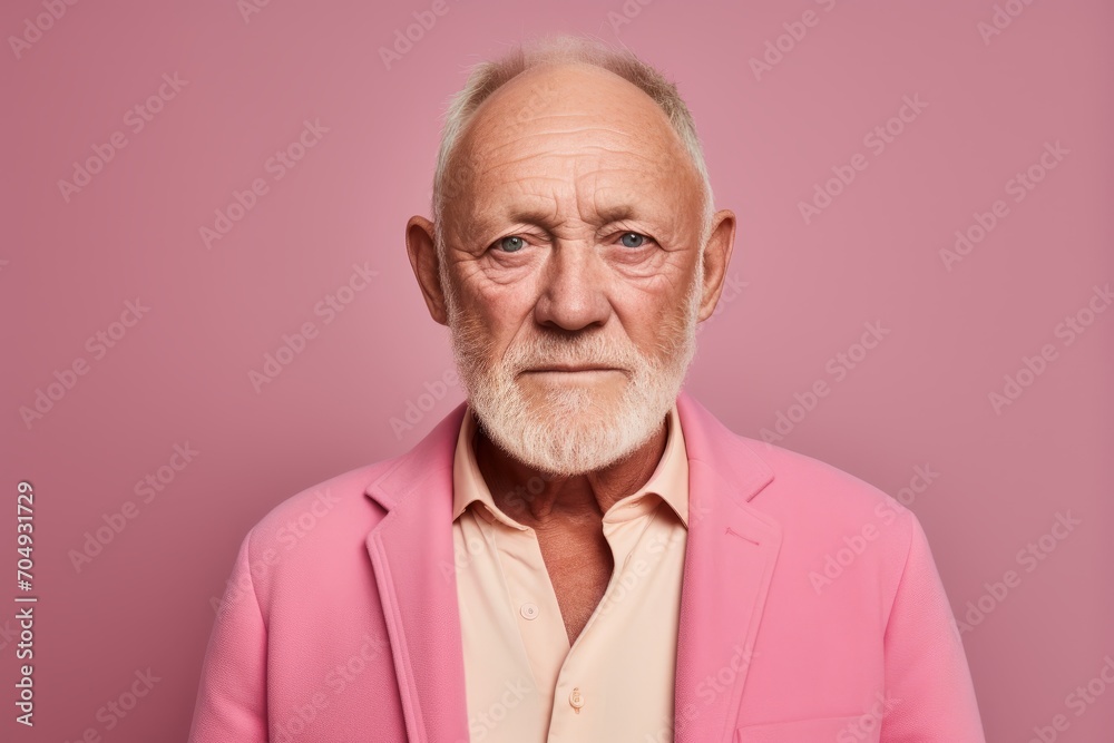 Portrait of an old man in a pink jacket on a pink background Portrait of an old man in a pink jacket on a pink background