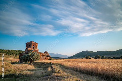Red church ruins in Nigde province, sunset colors and clouds in the sky