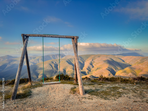 Wooden swing at Sao Pedro do Sul, with a beautiful view of Serra da Arada, in the center of Portugal.