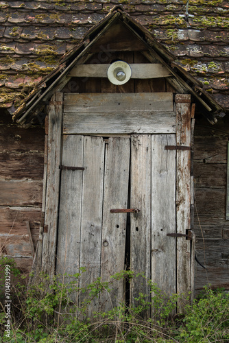 Sunja , Croatia, 05,04,2021: Old wooden rustic door on rural home wall.