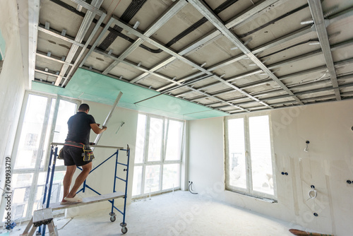 Wallpaper Mural Drywall Installers. Men holding a gypsum board figured cut Torontodigital.ca