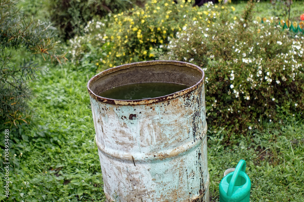 Old metal barrel with water in the village