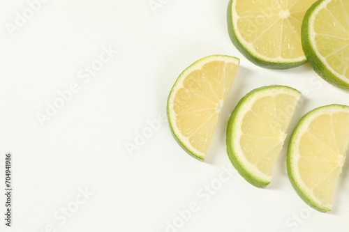 Lime pieces on white background, above view. Space for text