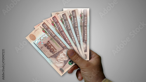 Guatemala quetzal growing pile of money in hand concept 3d illustration photo