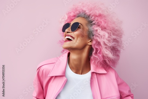 Fashion portrait of smiling african american woman in pink wig and sunglasses