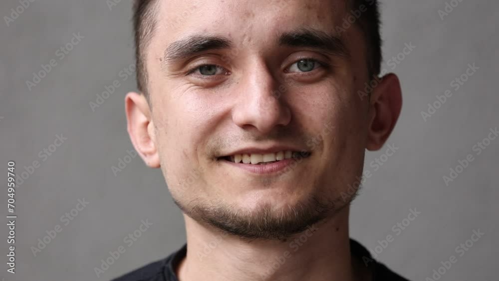 Portrait young cheerful friendly man smiles with white teeth and looks at camera. Otimistic caucasian male generation z face with short light beard and clear skin. International Day of Friendship. Portrait young cheerful friendly man smiles with white teeth and looks at camera. Otimistic caucasian male generation z face with short light beard and clear skin. International Day of Friendship.