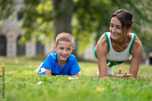 Fit woman and her son exercising in the park