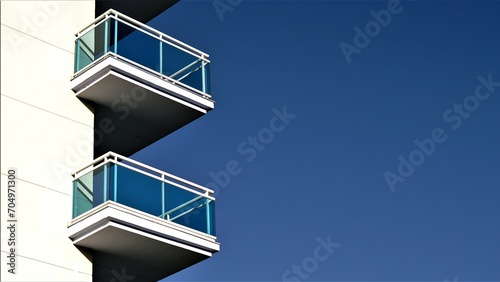 balconies with glass railing against the sky