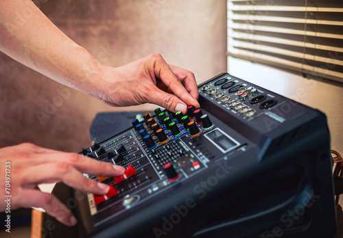 Sound engineer hands adjusting control sound mixer in recording, broadcasting studio,Sound mixer. Professional audio mixing console, buttons, faders and sliders. sound check. © NARONG