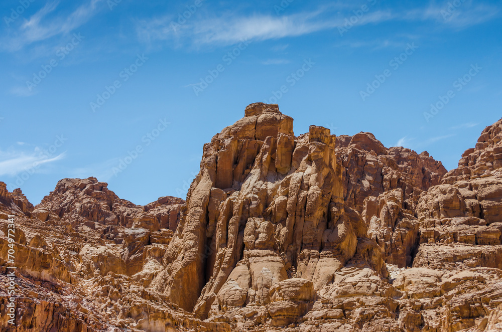 Fototapeta premium high rocky mountains against a blue sky and white clouds in Egypt Dahab South Sinai