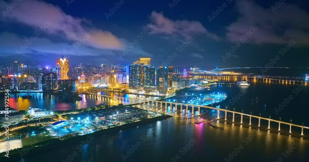 Aerial pan shot of Macau financial district buildings and cross-sea bridge at night Aerial pan shot of Macau financial district buildings and cross-sea bridge at night