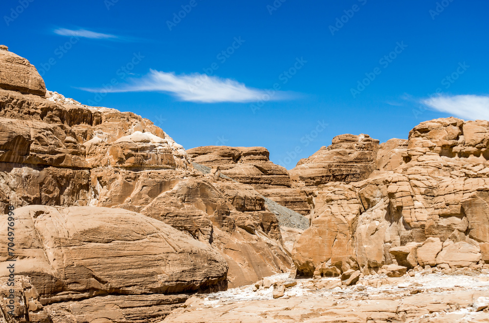 high rocky mountains in the desert against the blue sky and white clouds in Egypt Dahab South Sinai
