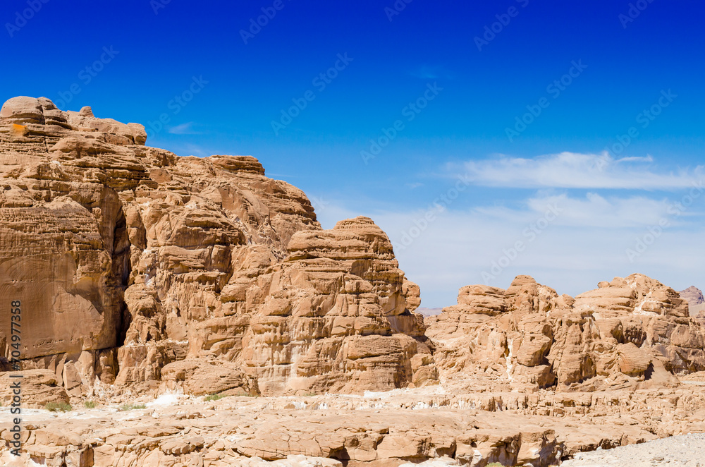 high rocky mountains against the blue sky and white clouds in the desert in Egypt Dahab South Sinai