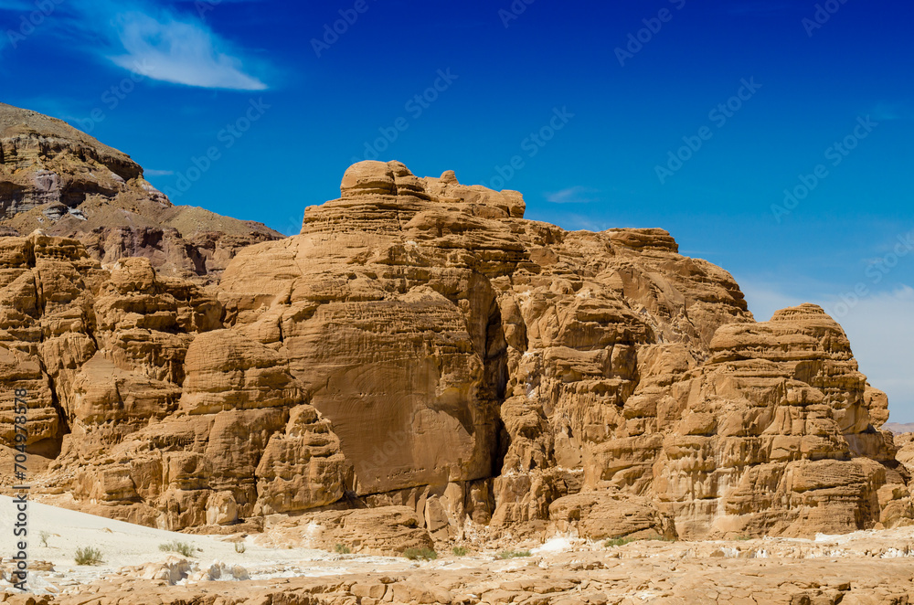 high rocky mountains against the blue sky and white clouds in the desert in Egypt Dahab South Sinai