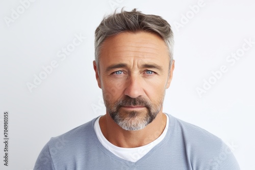 Handsome mature man with grey hair and beard looking at camera