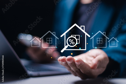 Real estate investment concept  Businessman use laptop with house icon for analyzing mortgage loan home and insurance real property mortgage. interest rate  Investment planning  business real estate.