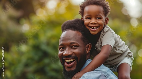 Happy man holding his baby on his back