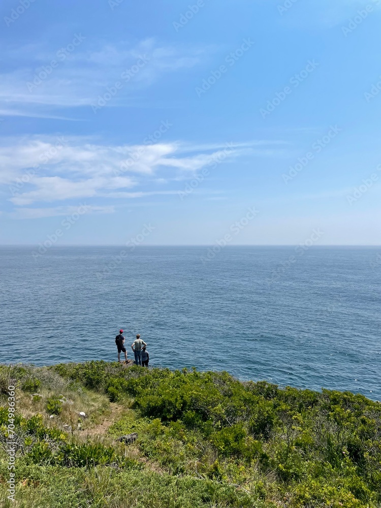 People overlooking the ocean on Monhegan Island Maine