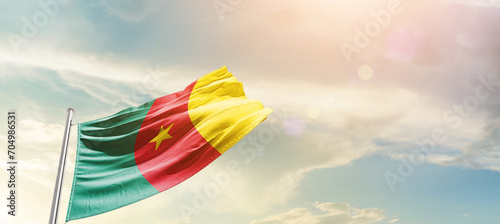 Cameroon national flag cloth fabric waving on the sky - Image photo