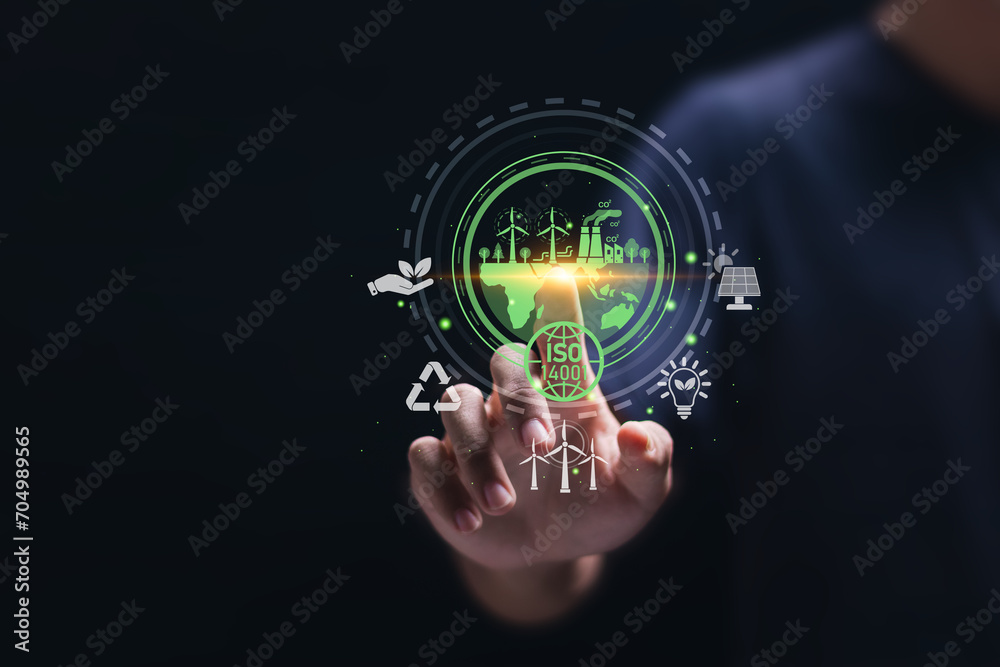 ISO 14001 concept. Businessman touch virtual icon of ISO 14001 certified for environmental management systems (EMS). Identify, control and reduce the environmental impact of activities. ISO 14001 concept. Businessman touch virtual icon of ISO 14001 certified for environmental management systems (EMS). Identify, control and reduce the environmental impact of activities.
