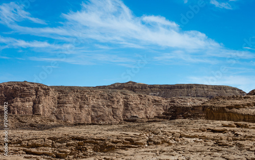 high rocky mountains in the desert against the blue sky and white clouds in Egypt Dahab South Sinai