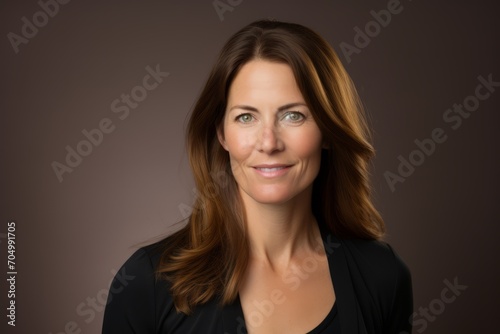 Portrait of a smiling businesswoman looking at camera over dark background