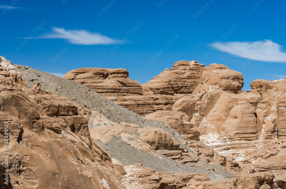 high rocky mountains in the desert against the blue sky and white clouds in Egypt Dahab South Sinai high rocky mountains in the desert against the blue sky and white clouds in Egypt Dahab South Sinai