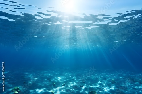 Underwater view of blue sea with sunbeams and lens flare © Saima