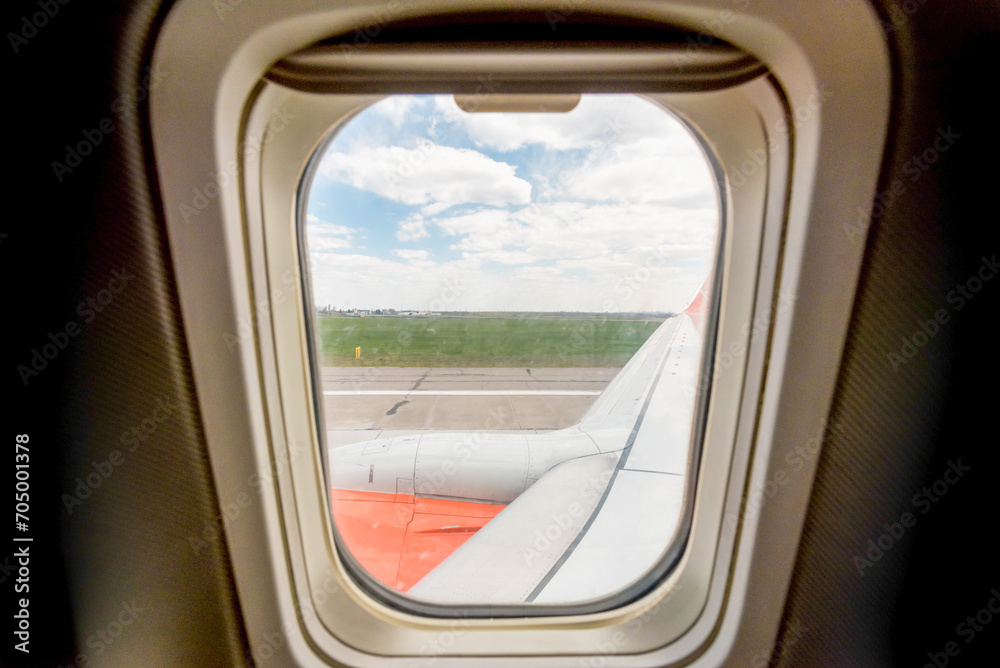 view from the airplane window of the airport during takeoff