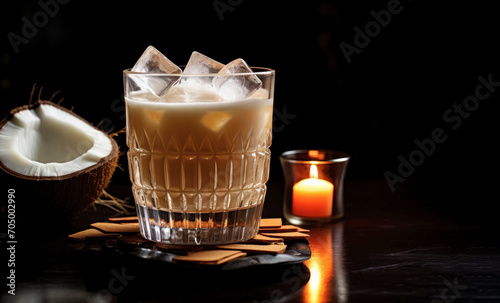 Exotic coconut cocktail in a textured glass with a rich golden hue on a dark background